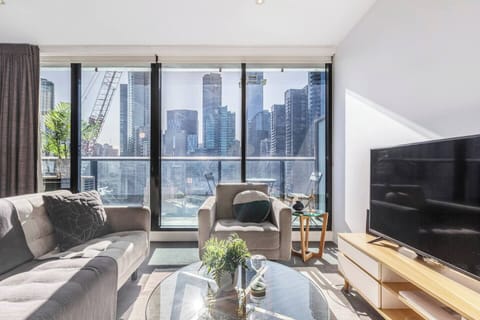 A haven of relaxation and style, the living area invites you to unwind with plush furnishings set against a backdrop of Melbourne’s city.
