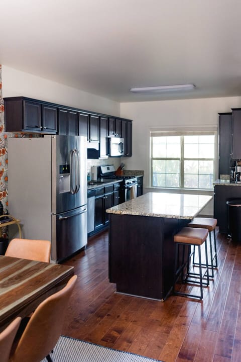 Gas stove, refrigerator with water/ice, microwave, dishwasher, and coffee bar.