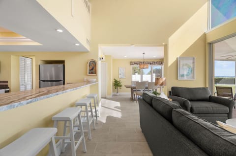Unwind in this bright, open-concept living space where you can gather around the stylish breakfast bar or sink into the plush sectional sofa.