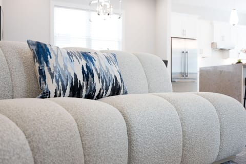 (1st Floor) Spacious living room with multiple seating, smart TV, and fireplace.