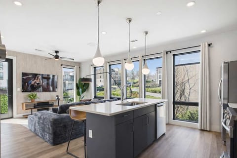 Bright living room with comfortable seating, smart TV, designer decor, and access to the private patio.