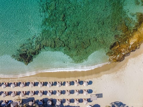 On the beach, white sand, sun loungers, beach umbrellas