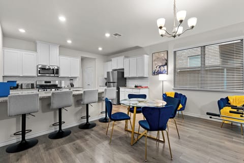 Open kitchen and dining area perfect for teams saving money by cooking meals instead of eating out.