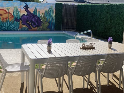 Outdoor dining room table overlooking the mural.