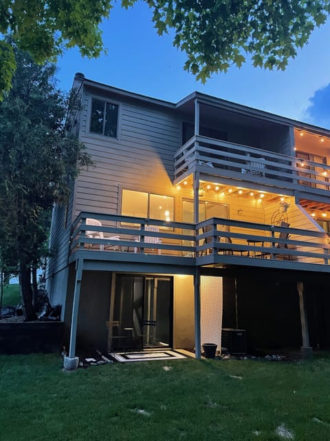 3 levels of outdoor seating overlooking a wooded area with amazing sunrise views