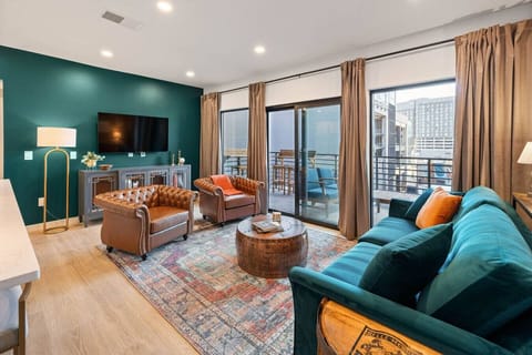 Speakeasy-inspired living room with downtown skyline views, flat screen TV w/cable, & queen sleeper sofa.
