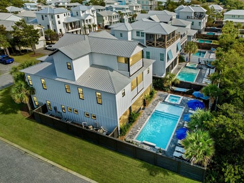 Groovy Goat - Sleeps 36! Private gated beach access and FREE golf cart included! Private backyard oasis with heated pool, hot tub, lounge chairs, hammocks, outdoor dining table, and screened in outdoor kitchen and lounge area