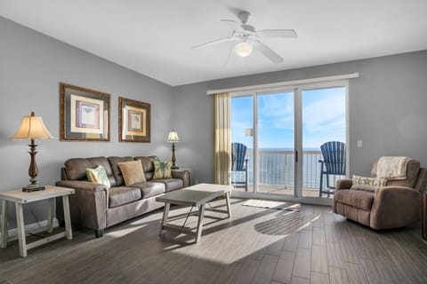 Living Room - A perfect blend of luxury and comfort, this beachfront living room has a soft sofa, a comfy recliner, a large flat-screen TV, and breathtaking ocean views through glass doors.