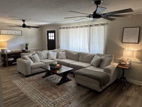 Large comfortable living room. Living room features a 65” Samsung TV! 