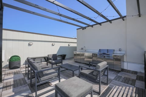 Spacious rooftop patio w/ lounge seating & open sky views for relaxing outdoors