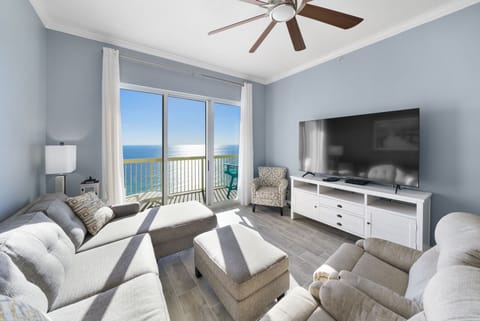 Relax in your bright oceanfront living room with stunning sea views and modern comforts like a big-screen TV and ceiling fan.