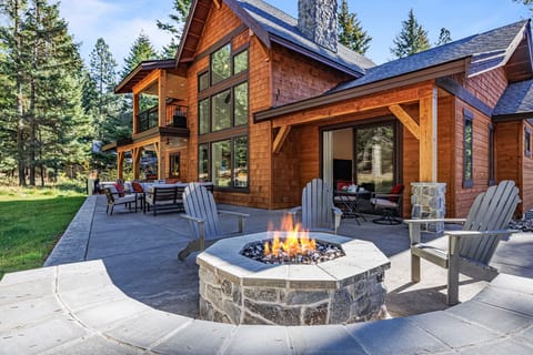 Outdoor gas fire pit with built-in seating — barrel sauna steps away