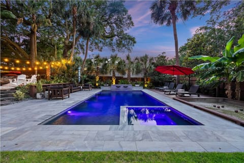 Large saltwater pool w/ attached spa. Pool-side furniture surrounding the pool.
