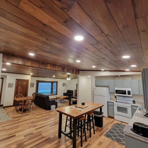 Kitchen dining & living room space. Check out the unique wood ceilings.