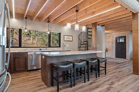 Charming kitchen setup with a sleek countertop and four chic chairs, perfect for a family meal