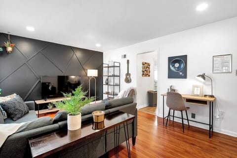 Cute Open Living Room with Smart TV and Workspace