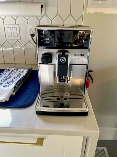 There is an espresso machine and coffee beans are provided as well as a variety of tea.