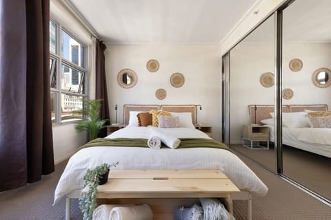 A cozy bedroom with a queen sized bed & plush pillows.