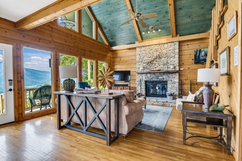 Comfort Cabin, 4 Bedrooms, Balcony, Mountain View | Living room | 75-inch TV with satellite channels, fireplace, foosball