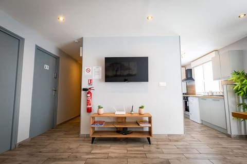 Standard Twin Room | Living area | Flat-screen TV, books