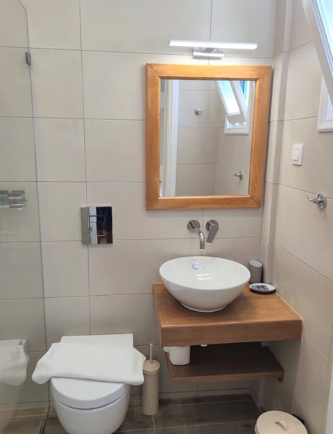 Shower, designer toiletries, hair dryer, towels