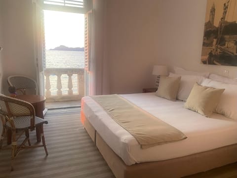 Romantic Double Room, Balcony, Sea View | 1 bedroom, in-room safe, desk, iron/ironing board