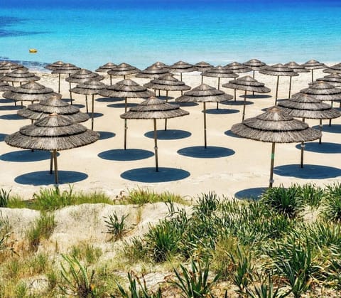 Beach nearby, white sand, beach umbrellas, beach towels