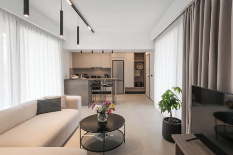 Superior Suite, City View | Living area | 32-inch flat-screen TV with satellite channels, books