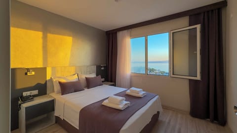Luxury Suite, 1 Bedroom, Sea View | 1 bedroom, minibar, desk, laptop workspace