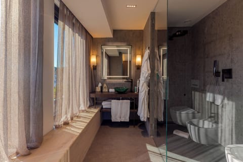 Junior Suite, Partial Sea View | Bathroom | Shower, rainfall showerhead, designer toiletries, hair dryer