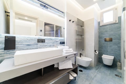 Deluxe Room, Non Smoking | Bathroom | Shower, hydromassage showerhead, hair dryer, slippers