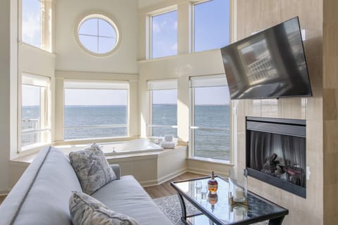 Luxury Suite, 1 Queen Bed, Fireplace, Bay View (Jacuzzi Left Bank) | Living area | 40-inch flat-screen TV with cable channels, TV, books