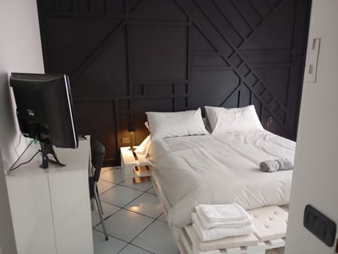 Quadruple Room, Courtyard View | Down comforters, individually decorated, individually furnished, desk