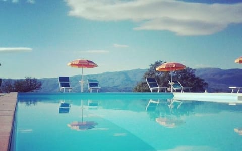 Seasonal outdoor pool, open 8:00 AM to 8:00 PM, pool umbrellas