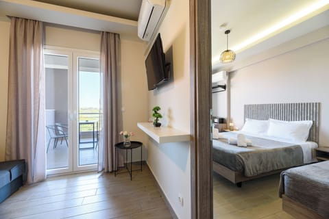 Family Apartment, Garden View | Living area | 43-inch Smart TV with satellite channels