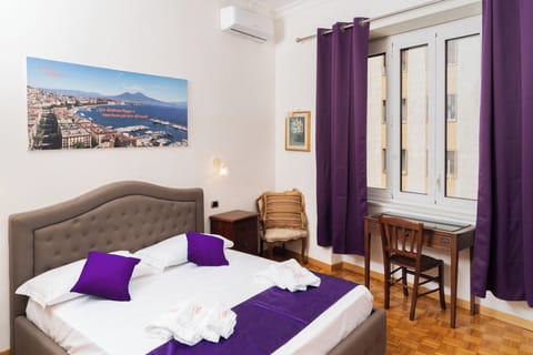 Deluxe Quadruple Room, City View | In-room safe, individually decorated, individually furnished, desk