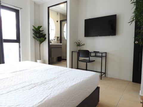 City Room | Desk, laptop workspace, blackout drapes, iron/ironing board
