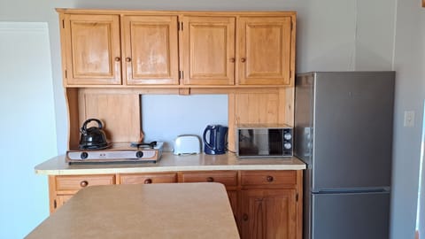 Apartment, Patio, Garden Area | Private kitchen | Full-size fridge, microwave, toaster, cookware/dishes/utensils