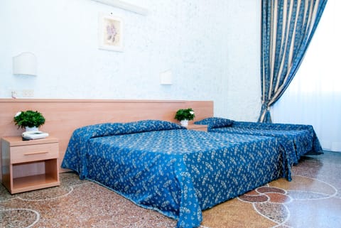 Standard Triple Room | Minibar, in-room safe, desk, blackout drapes