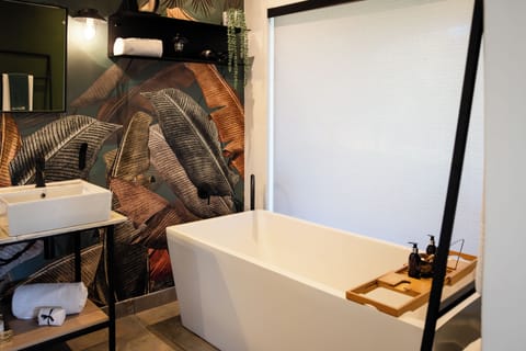 Separate tub and shower, hair dryer, soap, shampoo