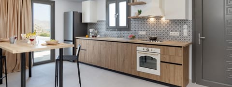 Deluxe Apartment | Private kitchen | Espresso maker, coffee/tea maker, electric kettle, highchair