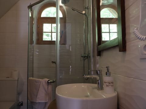 Shower, hair dryer, slippers, towels