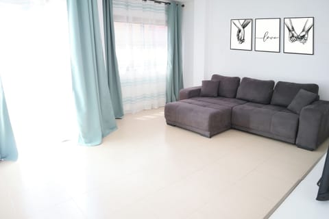 Comfort Apartment | Living area | 55-inch Smart TV with cable channels