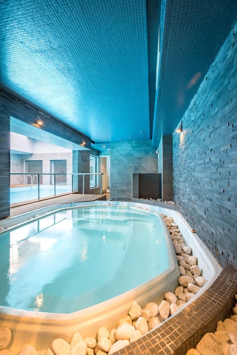 Indoor pool, seasonal outdoor pool, pool umbrellas, sun loungers