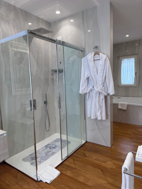 Luxury Suite, Balcony, City View | Bathroom | Hair dryer, bathrobes, slippers, towels