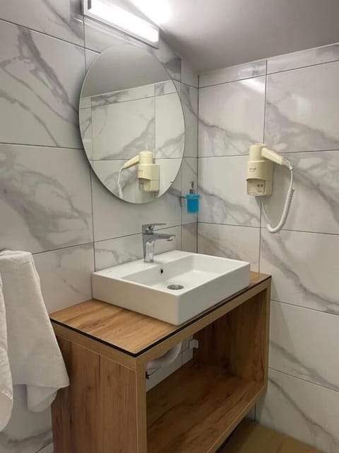 Shower, hair dryer, slippers, towels