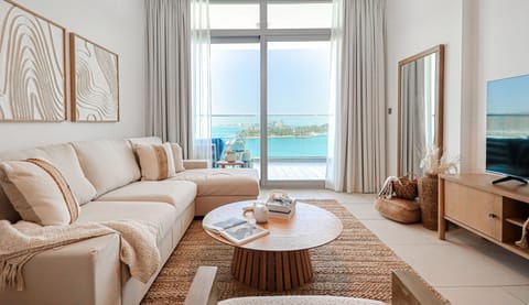 Deluxe Apartment, Balcony, Sea View | Living area | 55-inch Smart TV with cable channels