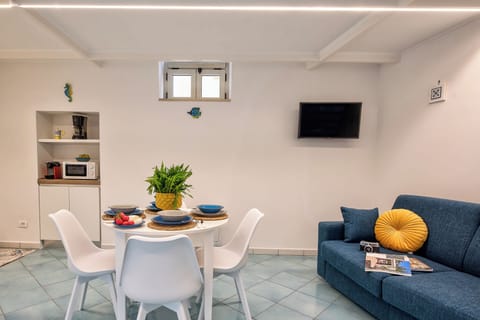 Apartment, Sea View | Living area | 32-inch flat-screen TV with cable channels