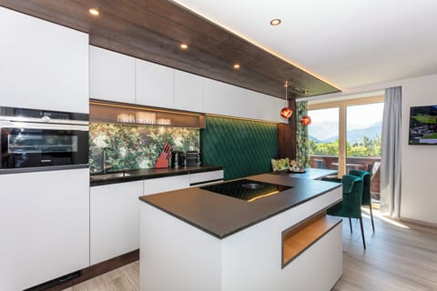 Deluxe Suite, Balcony, Mountain View | Living area | TV