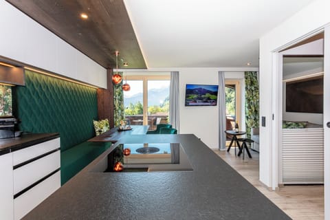 Deluxe Suite, Balcony, Mountain View | Living area | TV